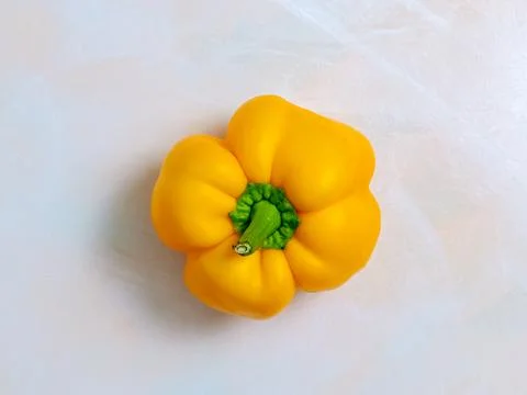 Yellow pepper, one, light background, photo from above, vegetarian food Stock Photos