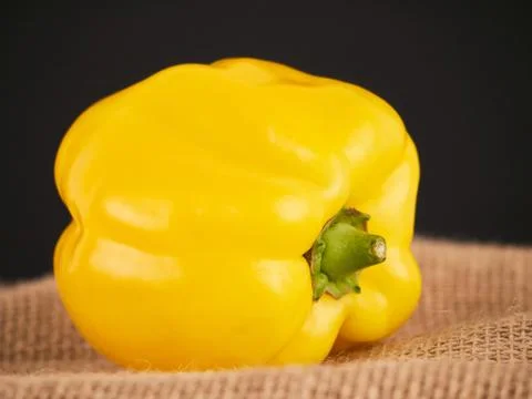 A yellow pepper with a rustic background Foto stock