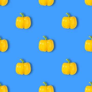 Yellow pepper seamless pattern on a blue background. Vegetable pattern Stock Photos