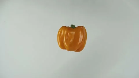 Yellow pepper spins in the air to the left fast Stock Footage 208965660