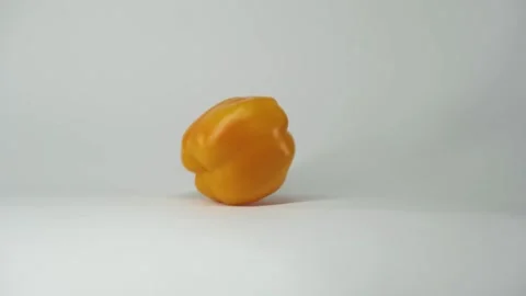 Yellow pepper spins on the floor Stock Footage 208965691