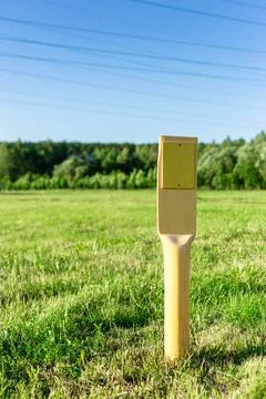 Yellow pillar with a sign - pointer. A warning. Stock Photos