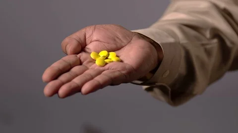 Yellow Pills In Hand Video stock 123317559