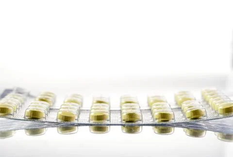 Yellow pills on white background Stock Photos