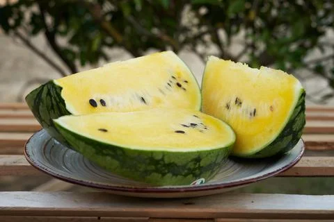 Yellow pineapple watermelon sliced on the table in the background tree greenery Stock Photos