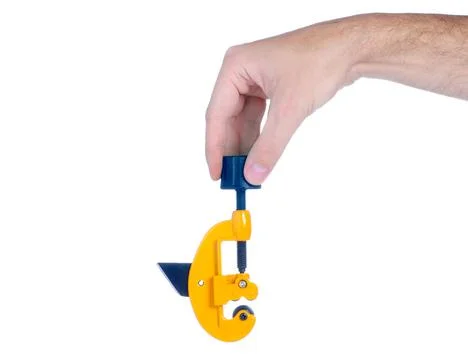 Yellow pipe cutter in hand Stock Photos