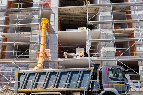 Yellow pipe installed for throw out industrial garbage, waste delay Stock Photos