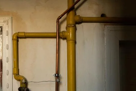 Yellow pipes from inside of the building. Stock Photos