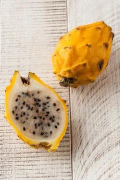 Yellow pitaya or dragon fruit whole and cut in half. Tropical fruits. Stock-Fotos