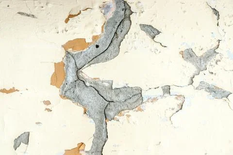Yellow plaster wheathered wall texture with cracks Stock Photos