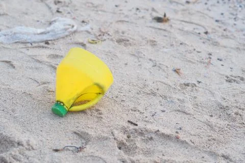 Yellow Plastic bottle on Beach Stock Photos