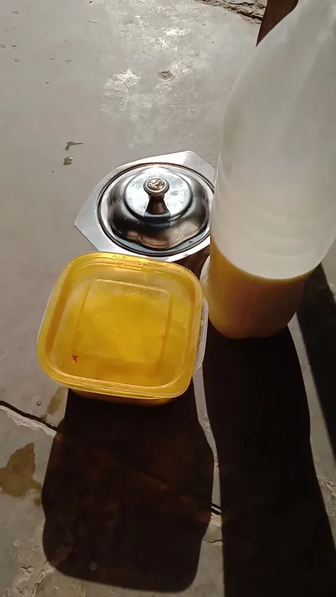 Yellow Plastic bowl and white milk bottle Sitting in a stainless steel bowl Stock Footage 322039935