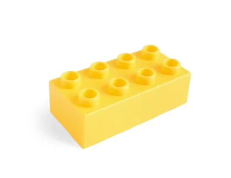 Yellow plastic building block on white background Stock Photos