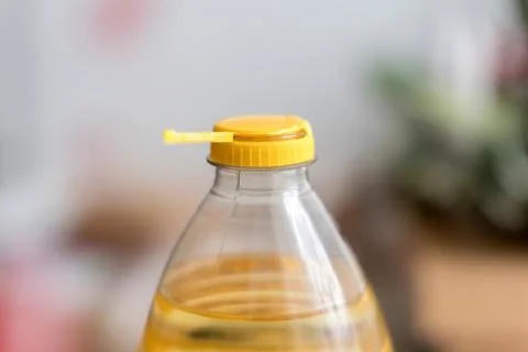 Yellow plastic cap for PET bottle with sunflower oil. New design with less pl Stock Photos