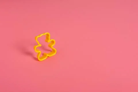 Yellow plastic cookie cutter for making cookies in the shape of a teddy bear  Stock Photos