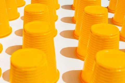 Yellow Plastic Drinking Cups in rows background Stock Photos