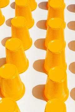 Yellow Plastic Drinking Cups in rows background Foto stock