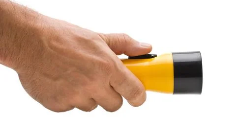 Yellow plastic flashlight in hand Stock Photos