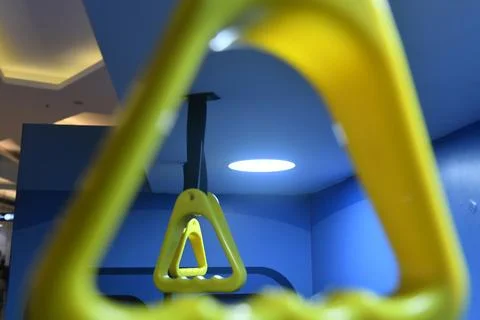 Yellow plastic handle on blue background Photos