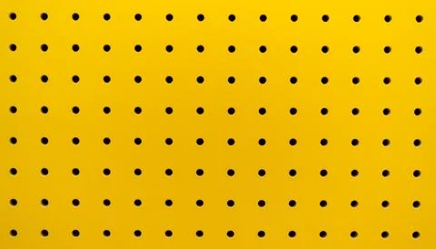Yellow plastic perforated panel texture. Seamless tile pegboard background 스톡 사진