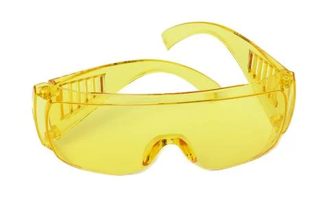 Yellow plastic protective goggles for workers on a white isolated background Foto stock