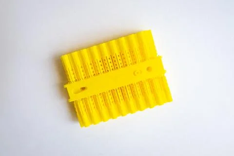 Yellow plastic raw plug anchor supports. Top view, isolated on white background. 写真素材