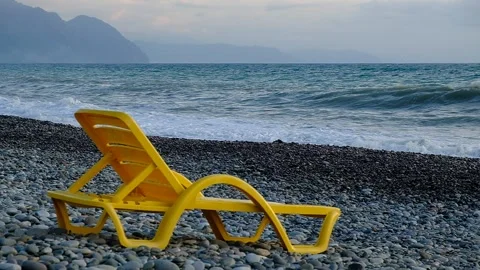 Yellow plastic sunbeds on the seashore. Stock Footage 134878250