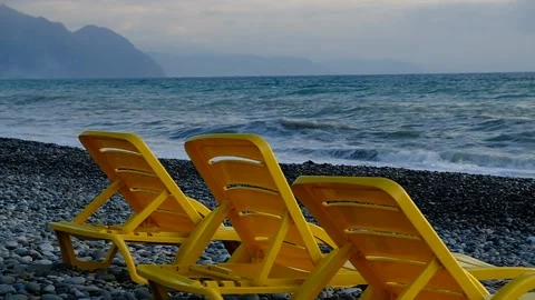 Yellow plastic sunbeds on the seashore. Stock Footage 134878289