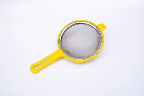 Yellow plastic Tea Strainer on White Background Foto stock