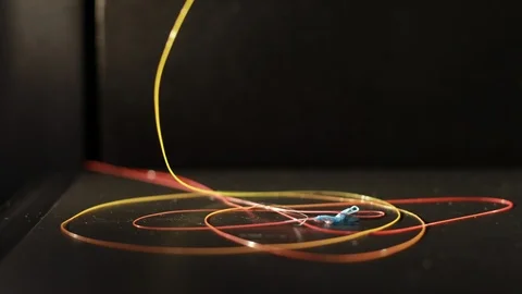 Yellow plastic thread that is printed by the 3D printer head. Stock Footage 124385084