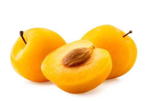 Yellow plums and half on a white background. Isolated. Stock Photos