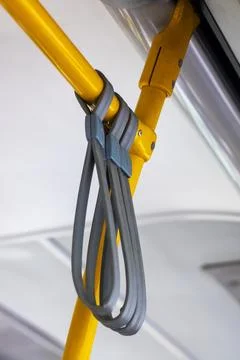 A yellow pole with a gray strap securely attached to it, Stock Photos