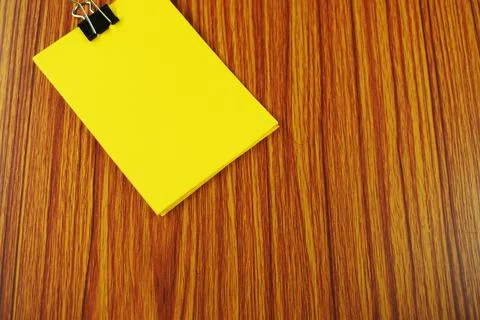 Yellow post it note attached to a board, with  push pin Stock Photos