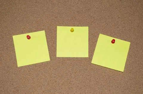 Yellow Post it Notes on a Cork Board Stock Photos