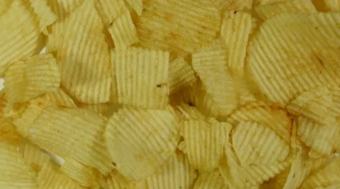 Yellow potato chips slowly rotating, close up, macro Video stock 47788428