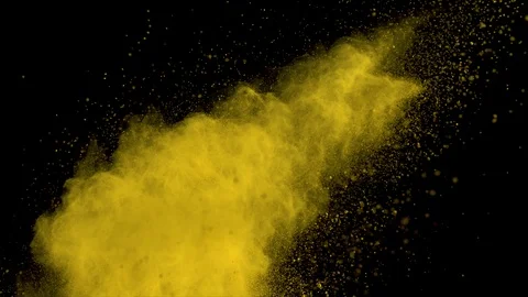 Yellow powder explosion on black background. Slow motion with acceleration Stock Footage 122434339