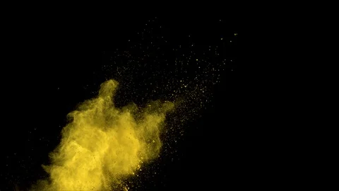 Yellow powder explosion in slow motion with acceleration in vertical motion Stock Footage 122447874