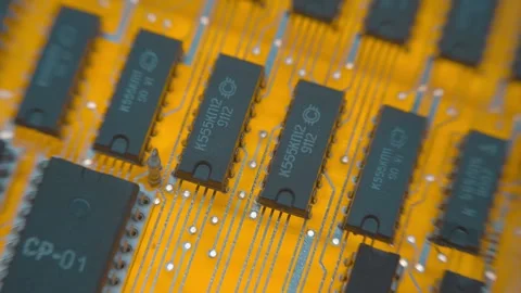 On yellow printed circuit board there are rows of microchips of different sizes Stock Footage 259789430