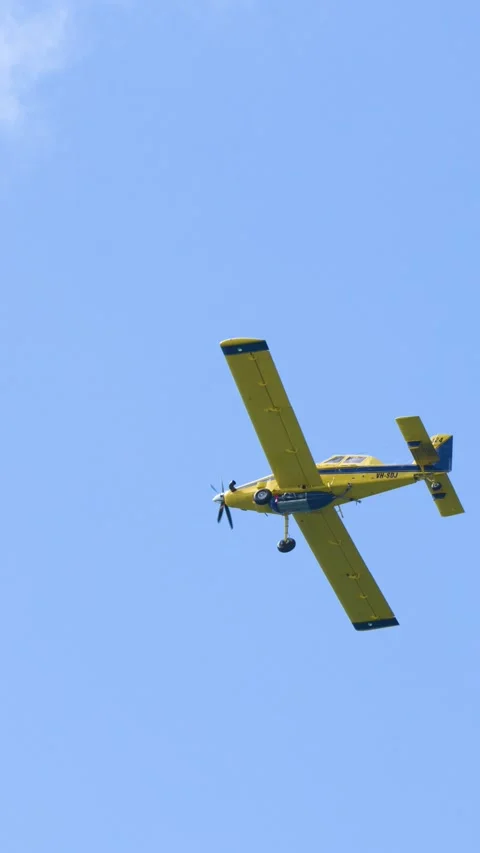Yellow Propeller Plane Flying Through Blue Sky in Gold Coast Stock Footage 344616009