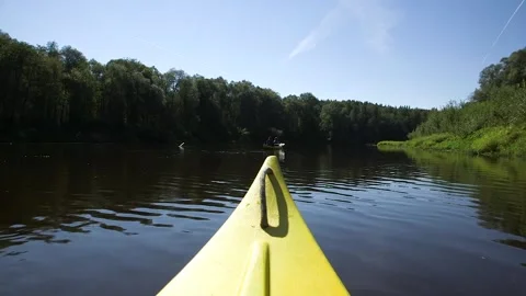 Yellow Prow of a Canoe Boating on a River Through a Forest Stock Footage 285144245