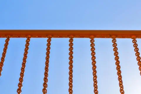 Yellow railing with chains Foto stock