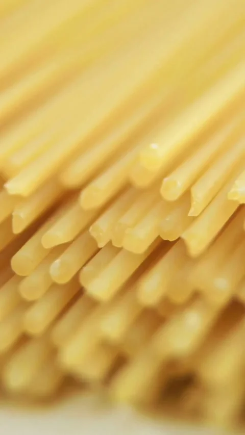 Yellow raw uncooked spaghetti pasta ends stacked macro detail Stock-Footage 334168705