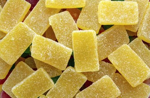 Yellow rectangular jelly candies pattern background. Yellow rectangular shaped Stock Photos