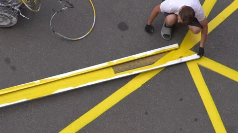 Yellow rectangular sign prohibiting parking on asphalt. Workers apply road Video stock 314997371