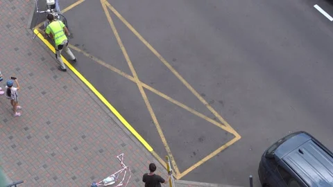 Yellow rectangular sign prohibiting parking on asphalt. Workers apply road Video stock 318061191