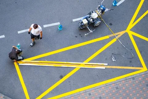 Yellow rectangular sign prohibiting parking on asphalt. Apply road markings w Stock Photos