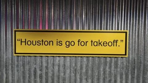 Yellow rectangular sign with the quote Houston is go for takeoff. in black .. Stock Photos