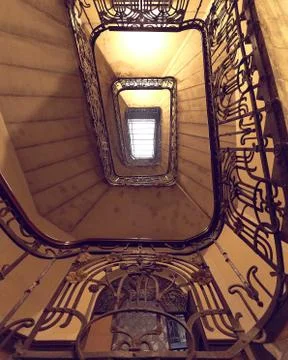 Yellow rectangular spiral staircase with black railings top view Stock Photos