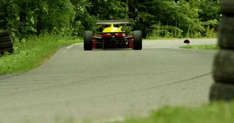 Yellow Red Black Formula Car Takes a Corner on a Hillclimb Vídeo Stock 340259944