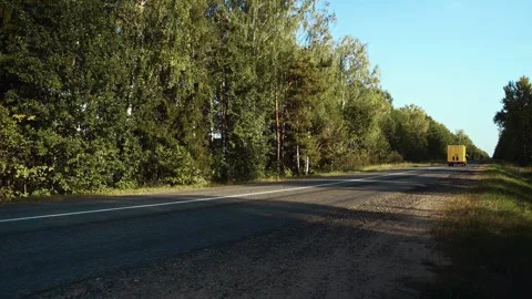 Yellow regional delivery box cube van driving on countryside single-lane road Stock Footage 268428390